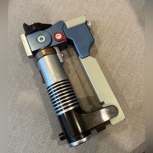Disney Parks original Light Saber. Retractable, operates with sound and light.